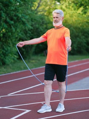 Senior man doing exercise with jump rope