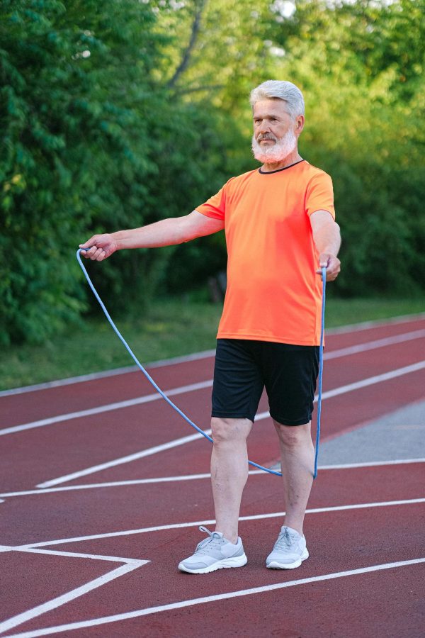 Senior man doing exercise with jump rope