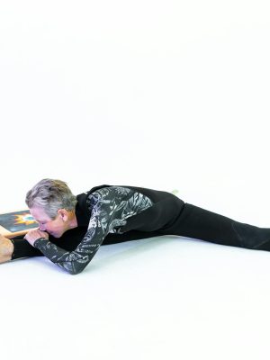 Womman In Black Active Wear Doing Stretching